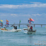 大漁旗を掲げて青い海を走る漁船-狩俣海神祭